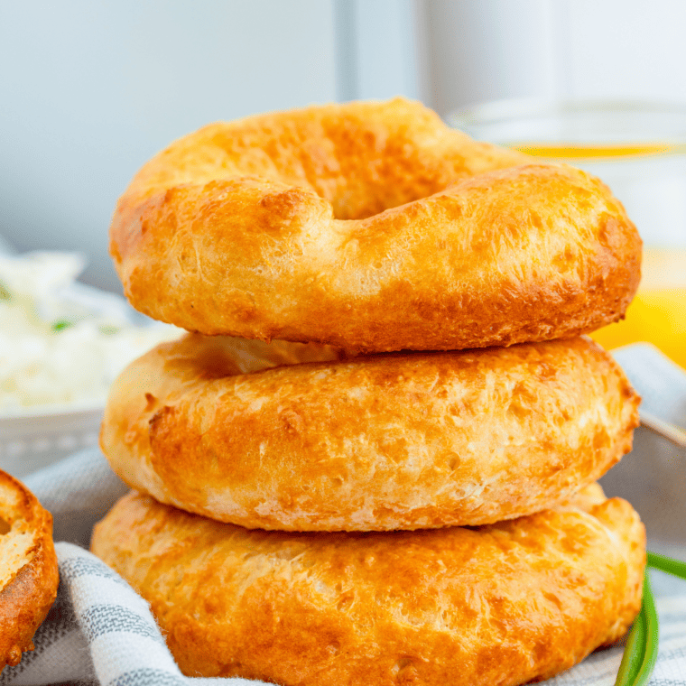 "Delicious 2-Ingredient Air Fryer Bagels topped with sesame seeds and resting on a wooden board"