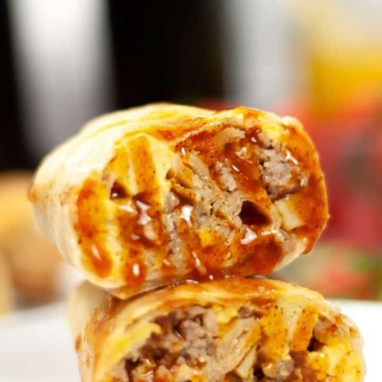 Air fryer breakfast chimichanga cut open to show the sausage, egg, and cheese filling