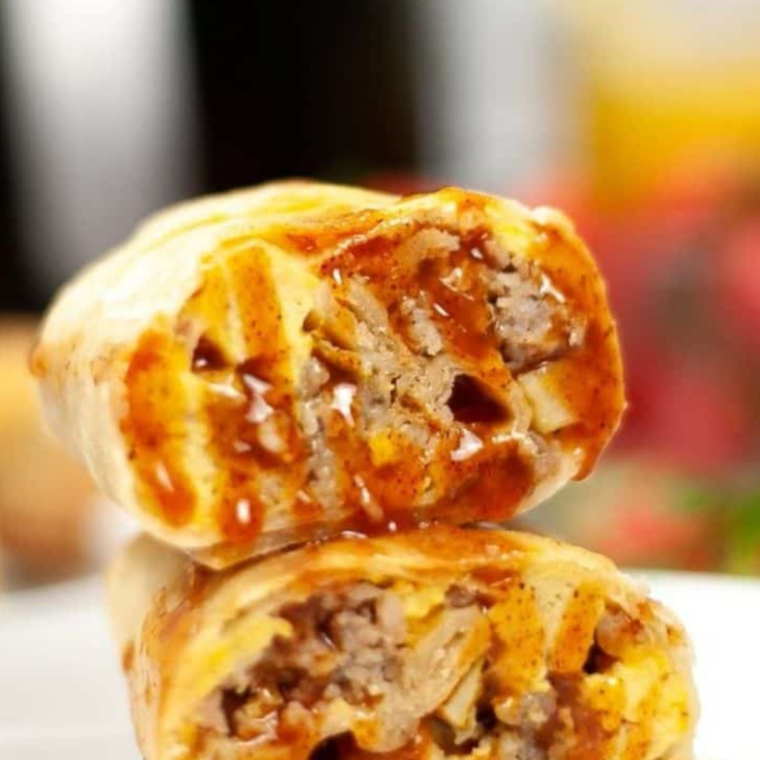 Air Fryer Breakfast Chimichangas stacked on a white plate with salsa