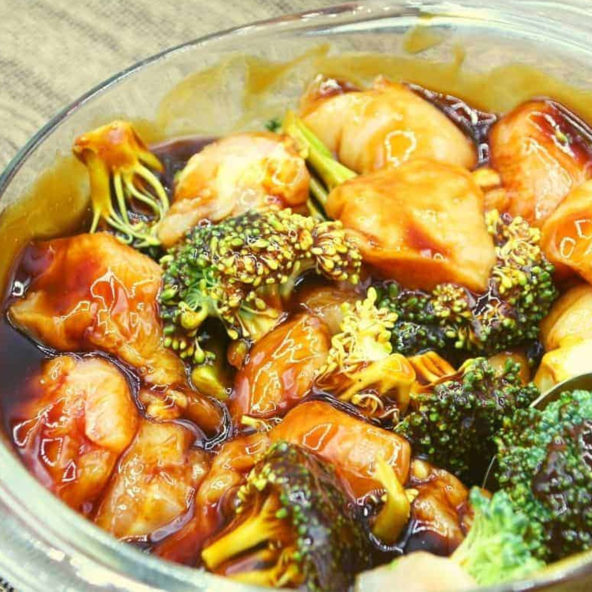 Ingredients in a bowl, mixed, coating the chicken and broccoli perfectly.