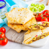 Crispy flour tortilla, seasoned beef, warm nacho cheese, a hidden crunchy tostada shell, lettuce, tomato, and sour cream — all folded into that famous hexagon shape and air-fried golden in 8 minutes.
