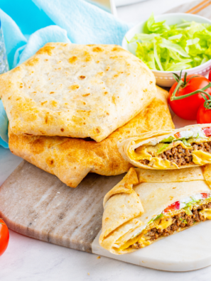 Crispy flour tortilla, seasoned beef, warm nacho cheese, a hidden crunchy tostada shell, lettuce, tomato, and sour cream — all folded into that famous hexagon shape and air-fried golden in 8 minutes.