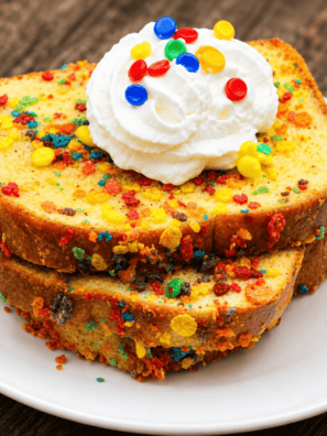 Air Fryer Fruity Pebbles French Toast on a white plate topped with whipped cream