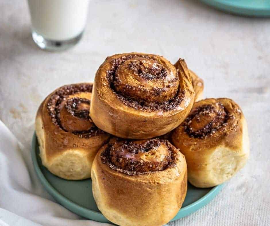 Freshly baked homemade cinnamon rolls topped with cream cheese frosting.