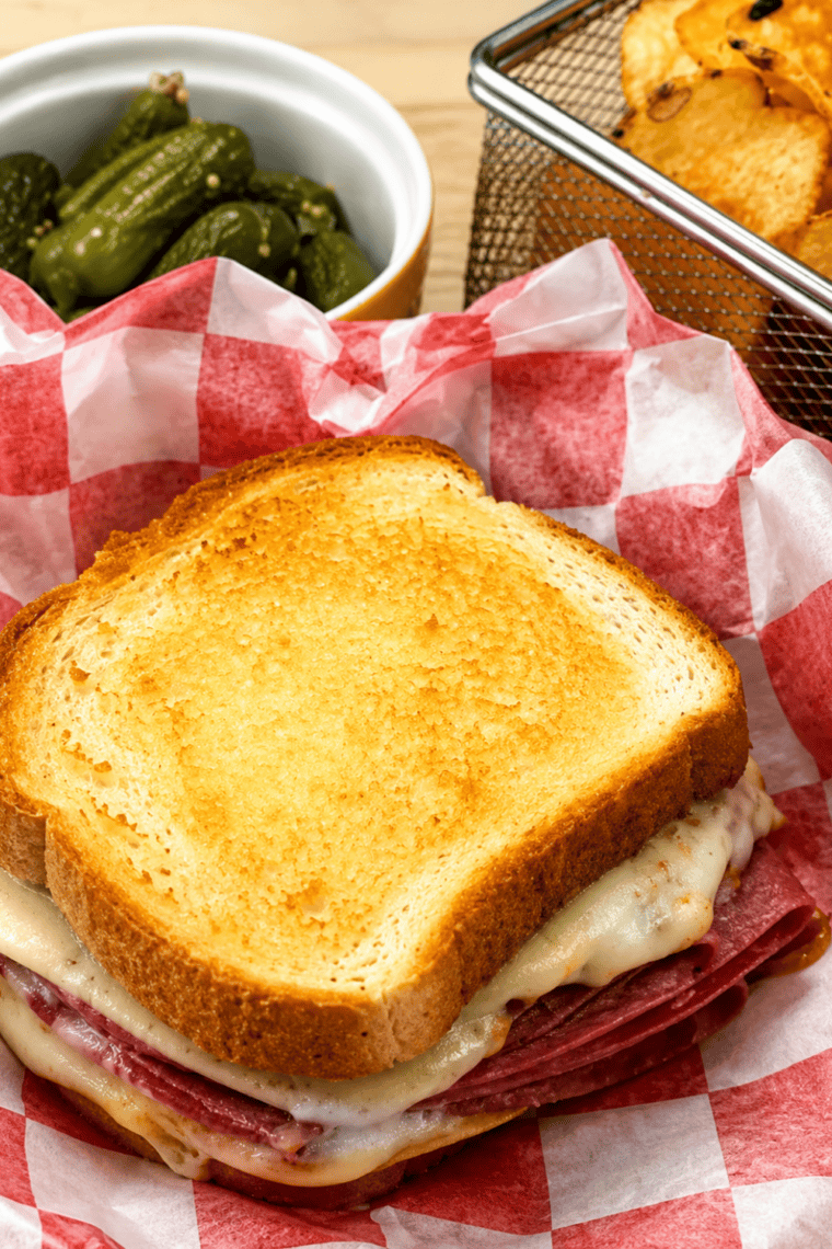 Golden crispy air fryer Italian grilled cheese sandwich stacked on a plate, ready to serve