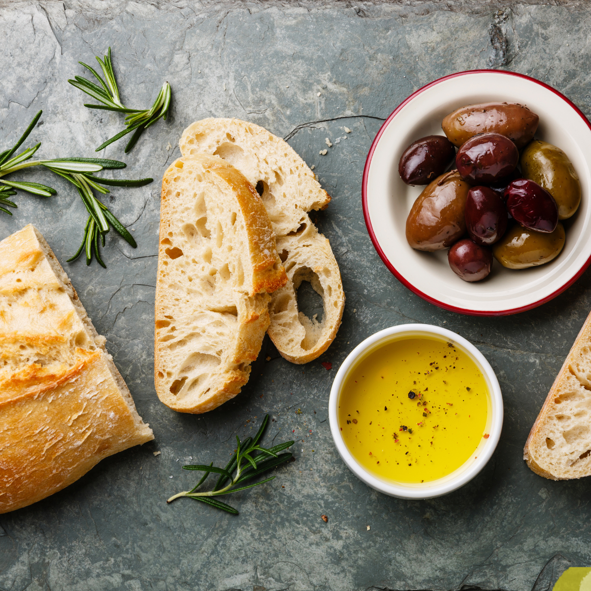 Ingredients needed for olive cheese bread on kitchen table.