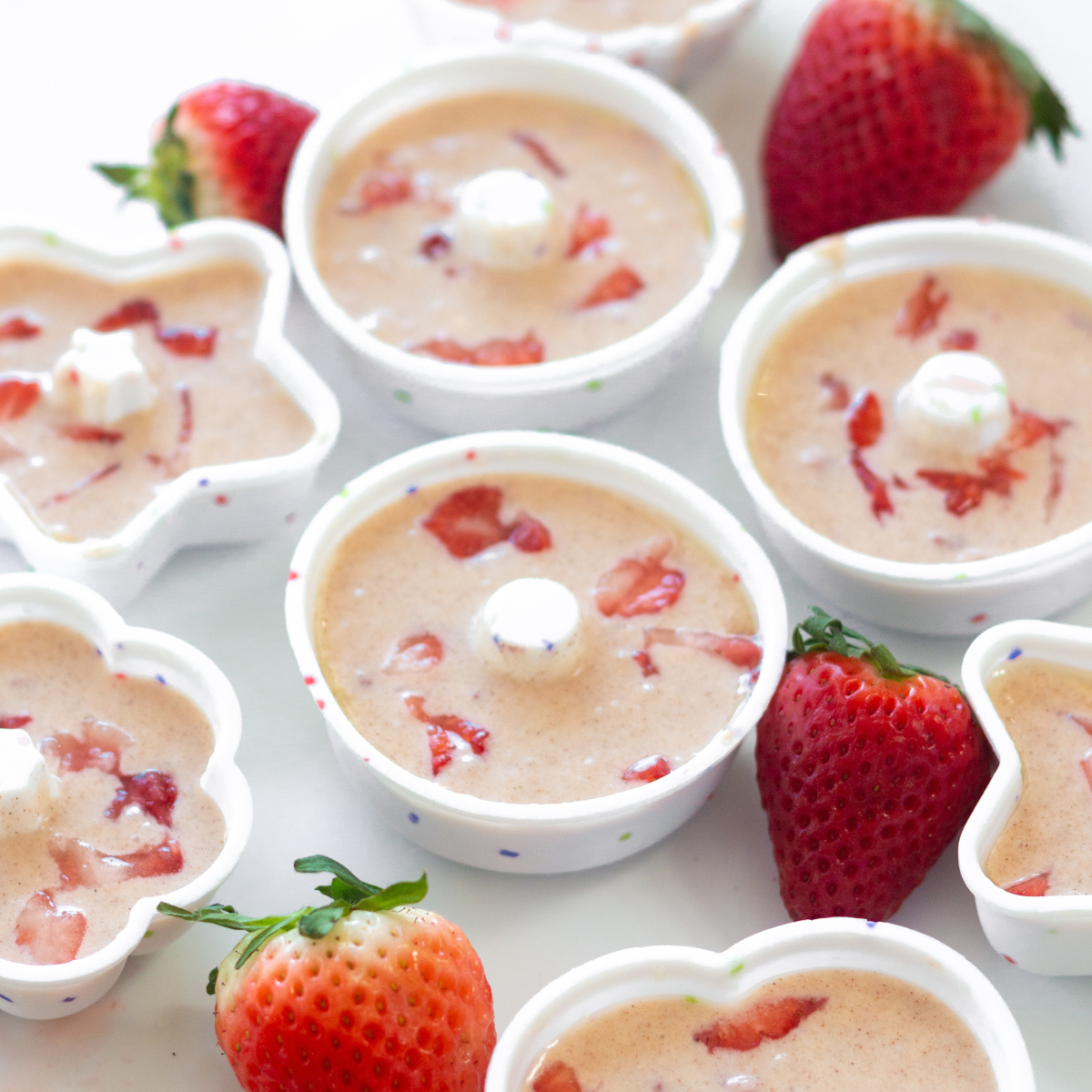 Strawberry donut batter spooned into greased silicone donut molds