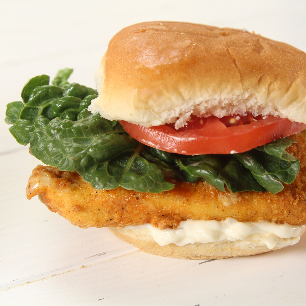 Air Fryer Wendy's Spicy Chicken Sandwich with crispy, golden chicken filet topped with lettuce, tomato, and spicy mayo, served on a toasted bun.