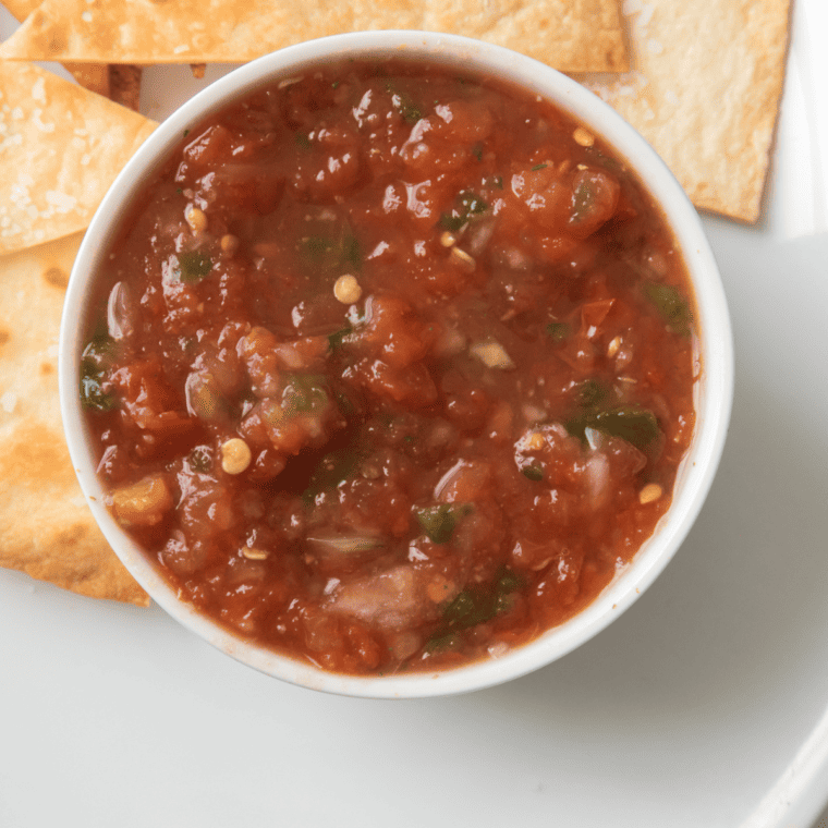 A small bowl of air fryer salsa with tortilla chips to the side