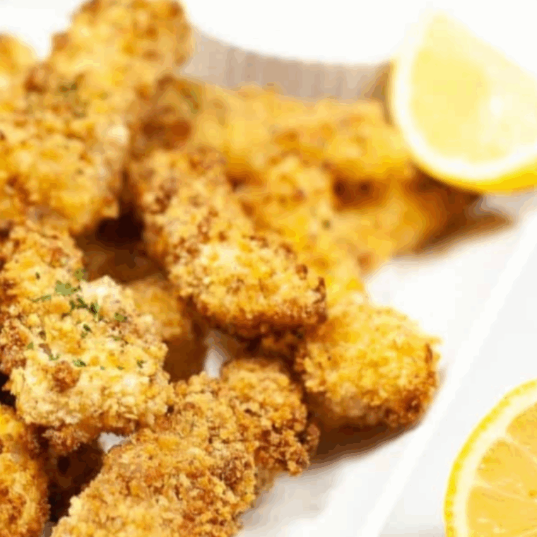 Golden crispy Captain D’s style fish sticks served with lemon wedges and dipping sauce.