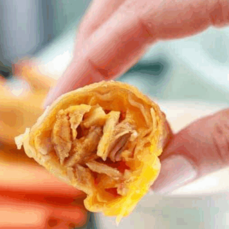 Golden air fryer buffalo chicken egg rolls with melted cheese and spicy chicken filling