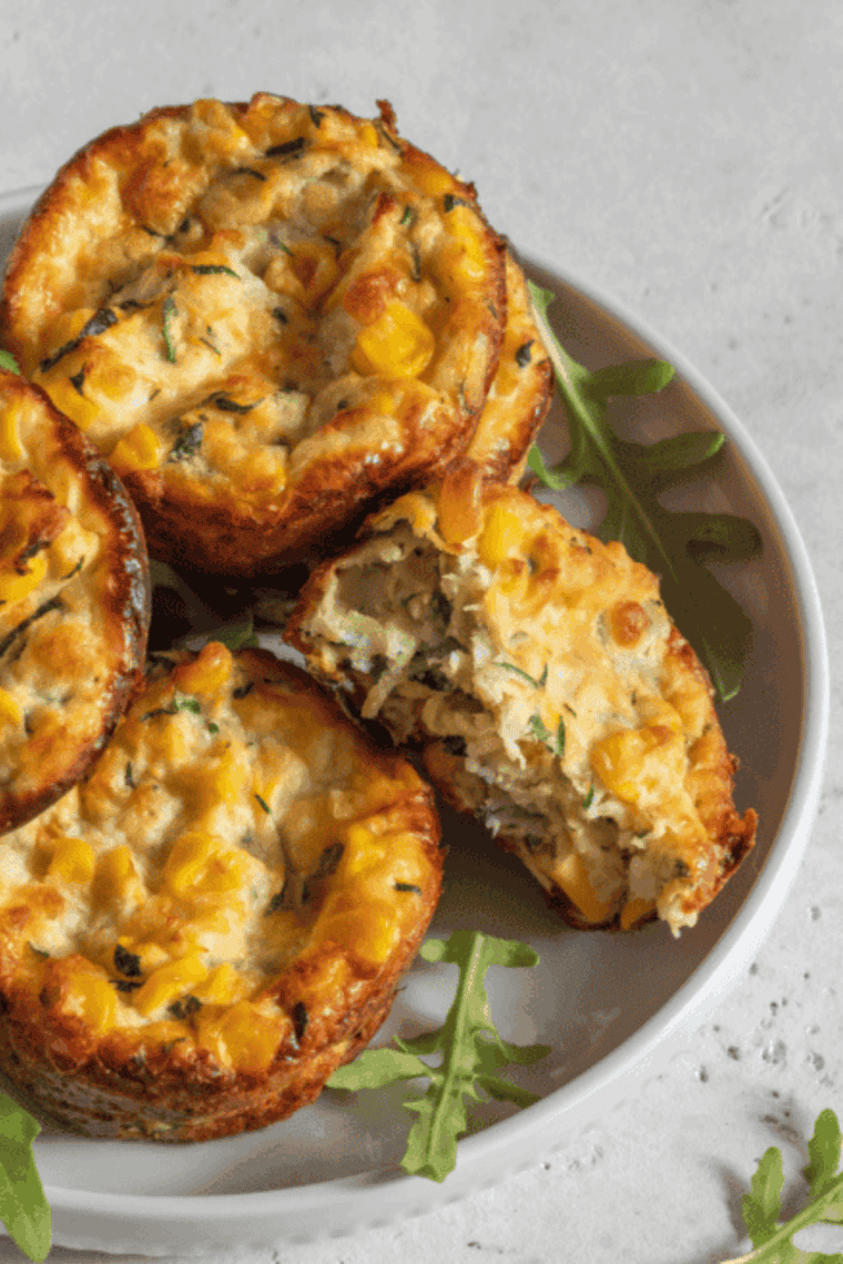 Golden, fluffy air fryer zucchini muffins with shredded zucchini in the batter