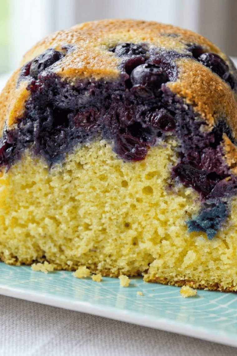 Soft blueberry lemon cornbread baked in a pan with juicy blueberries and lemon zest, served warm as a sweet breakfast or brunch treat.