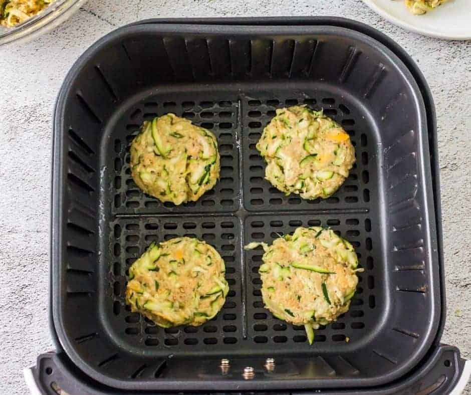 Arranging formed fritters in the Air Fryer basket, ready for cooking.