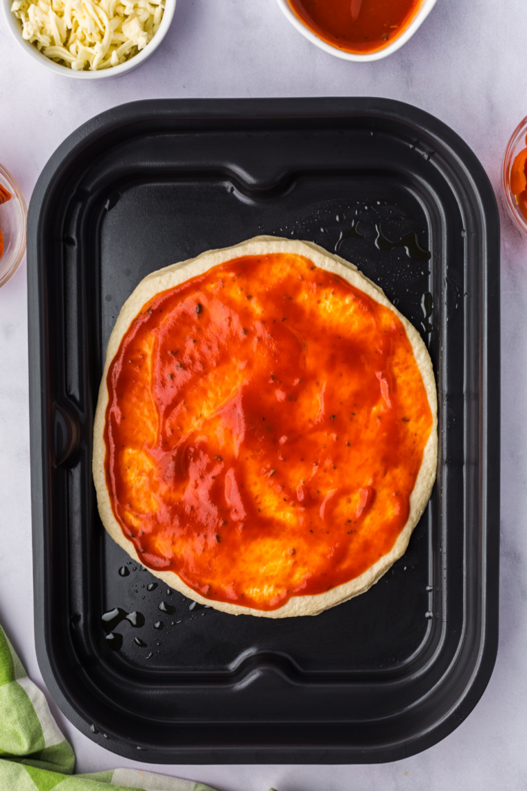 Person deciding between basket and oven air fryer for home cooking
