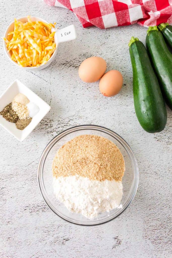Ingredients Needed For Air Fryer Zucchini Fritters on kitchen table.