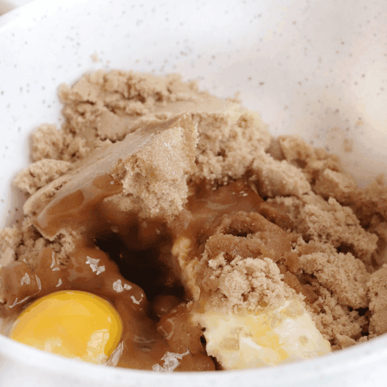 Mixing in eggs and vanilla extract into the creamed butter-sugar mixture.