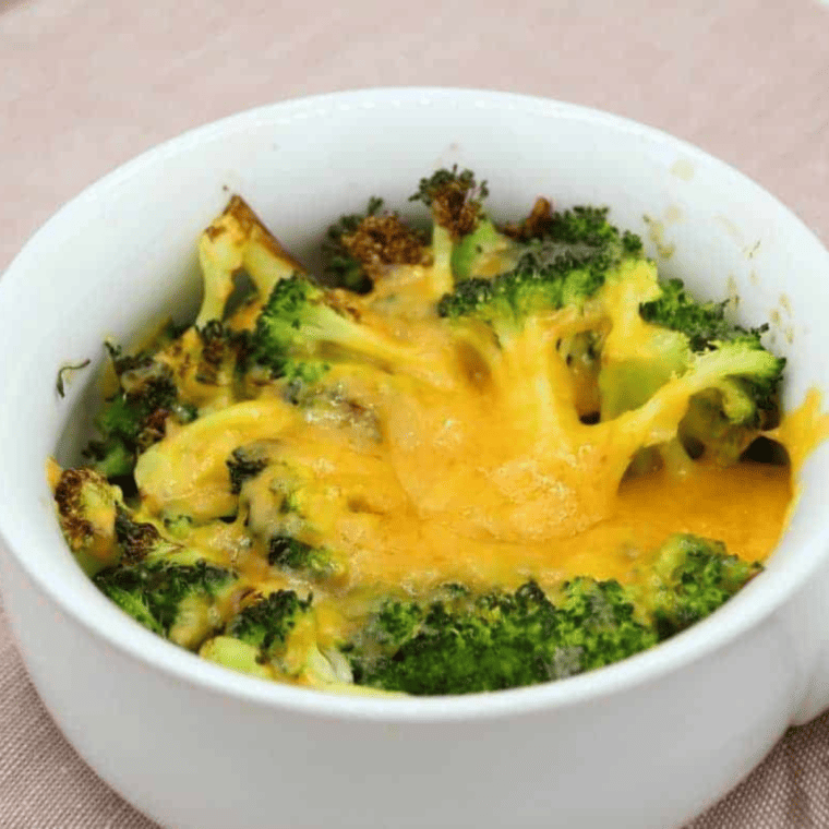 Air fryer broccoli with cheese sauce served as a side dish"