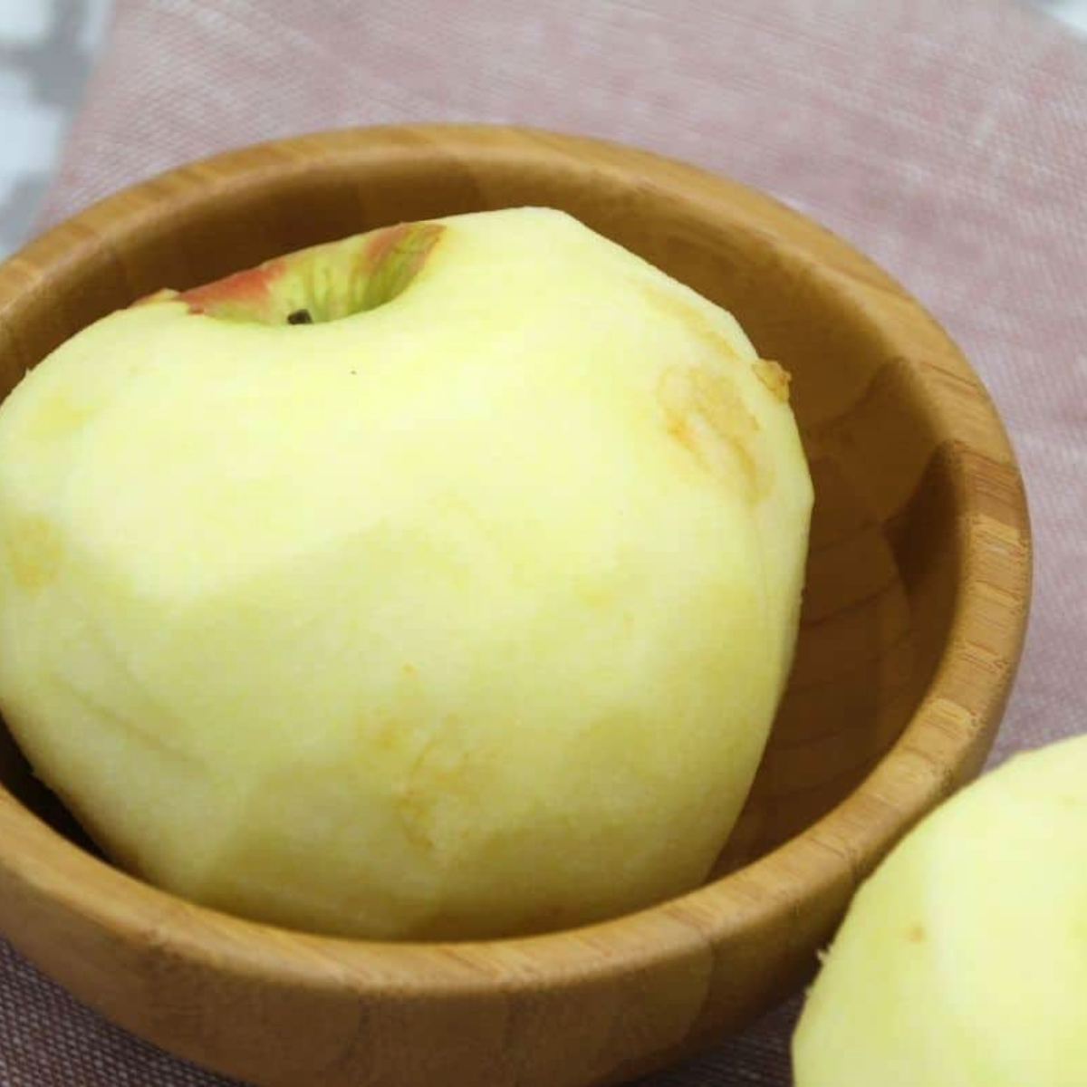 Prepare fresh apples by peeling, coring, and slicing them into even pieces.