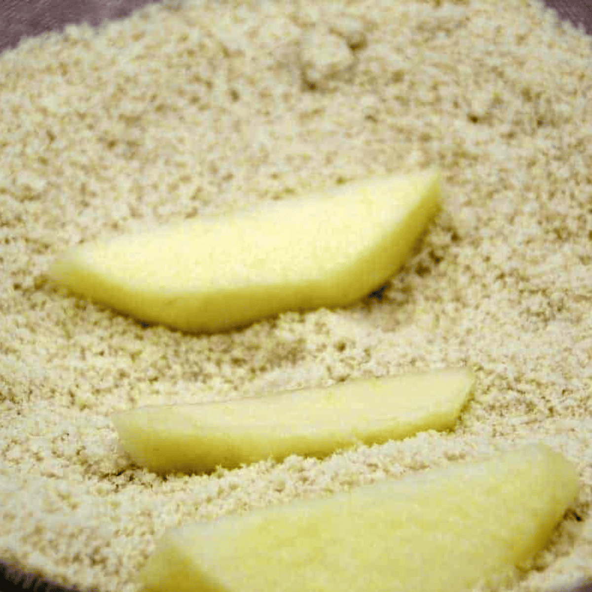 Toss apple slices with cinnamon and sugar to create a sweet, spiced coating.