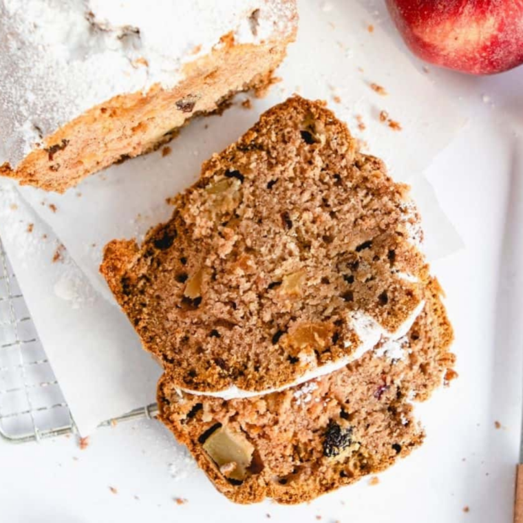 Slice of air fryer apple cranberry bread showing apple chunks and burst cranberries