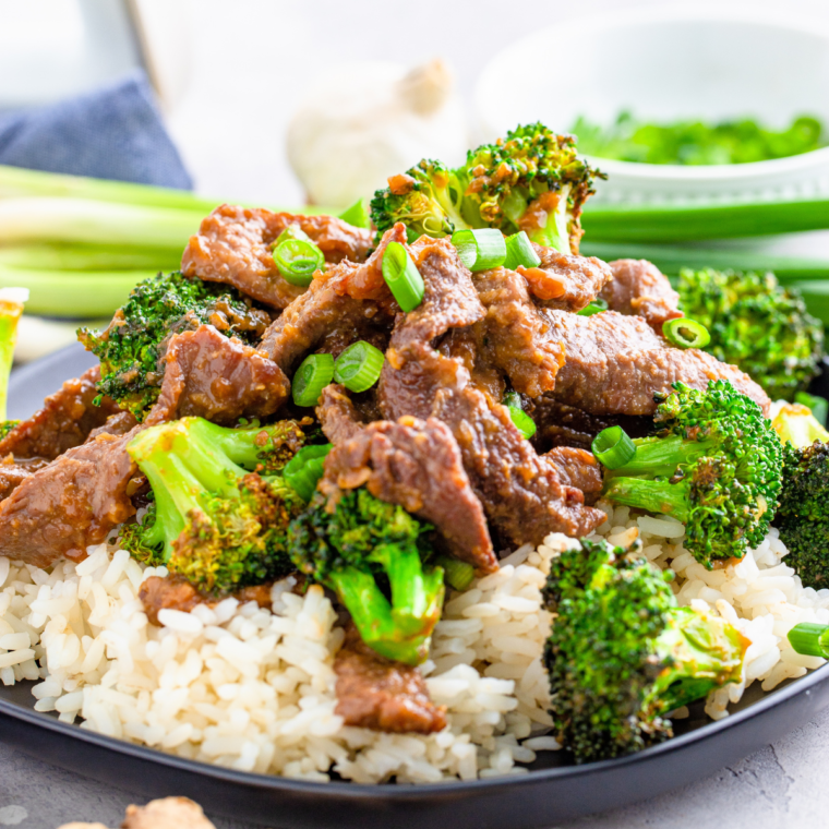 A delicious plate of Air Fryer Beef and Broccoli with tender beef, crispy broccoli, and savory sauce, garnished with sliced scallions.