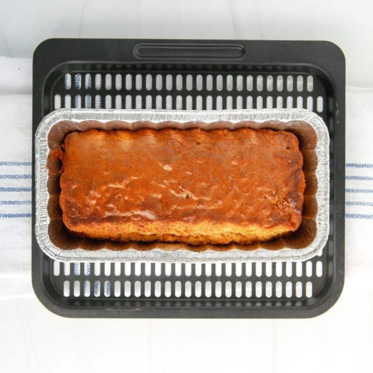 Carrot cake topped with a smooth layer of cream cheese frosting, ready to be served.