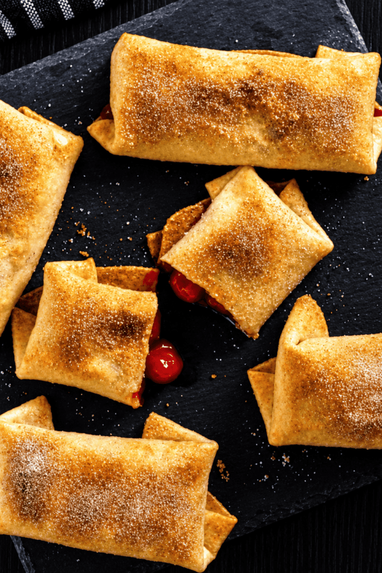 Close-up of a crispy air fryer cherry chimichanga coated in cinnamon sugar