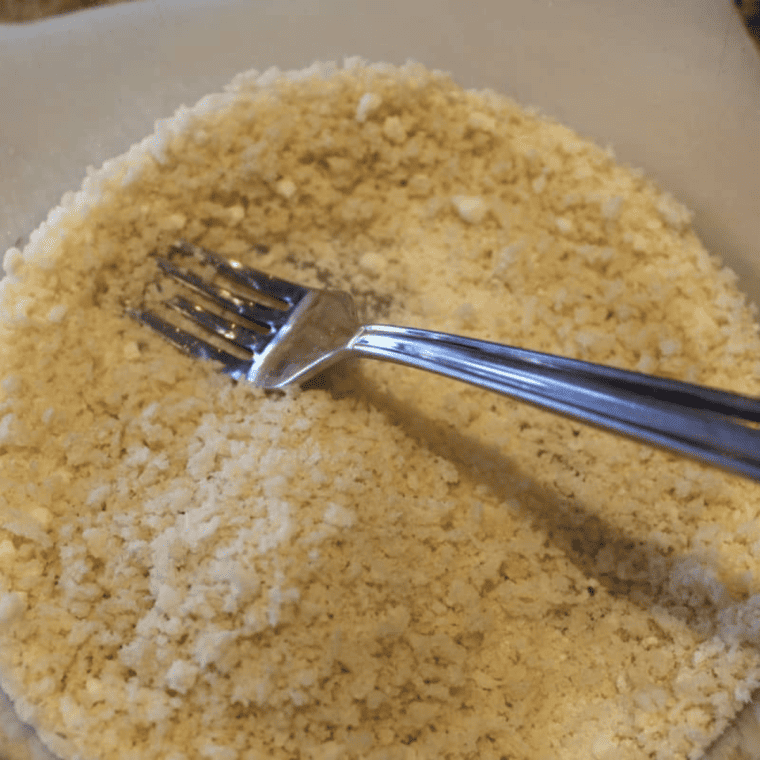 Three-bowl breading station with flour, beaten egg, and panko Parmesan mixture