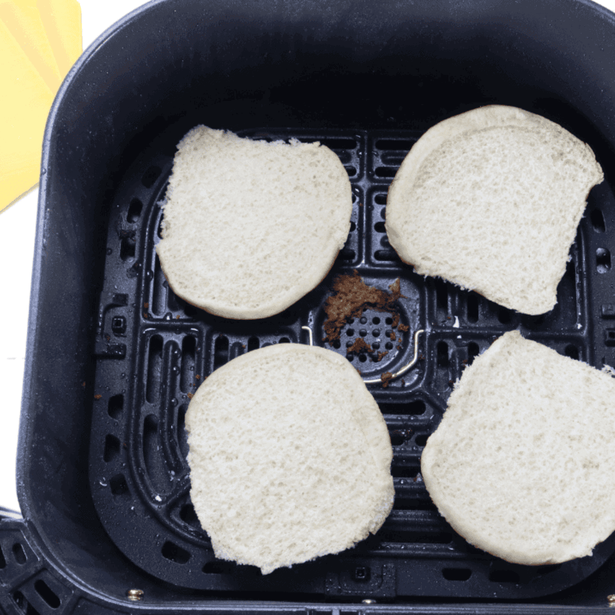 Adding hamburger rolls to the air fryer basket and air frying at 320Β°F for 2-3 minutes until toasted.