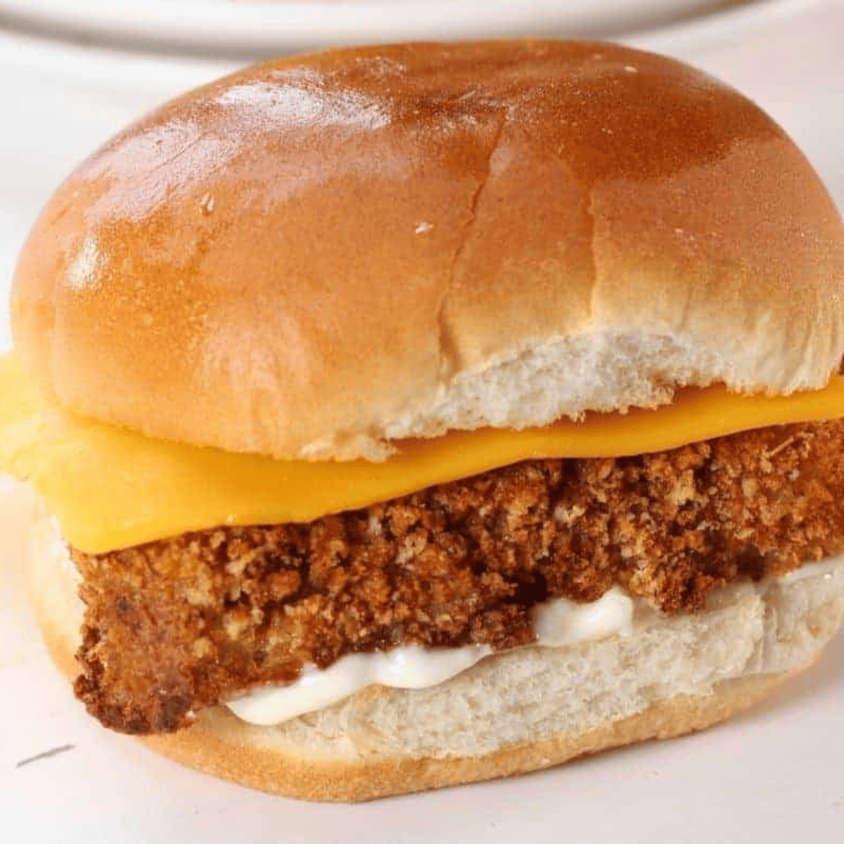 A golden, crispy Air Fryer Filet-O-Fish sandwich with a perfectly battered fish fillet, lettuce, and tartar sauce, ready to enjoy.