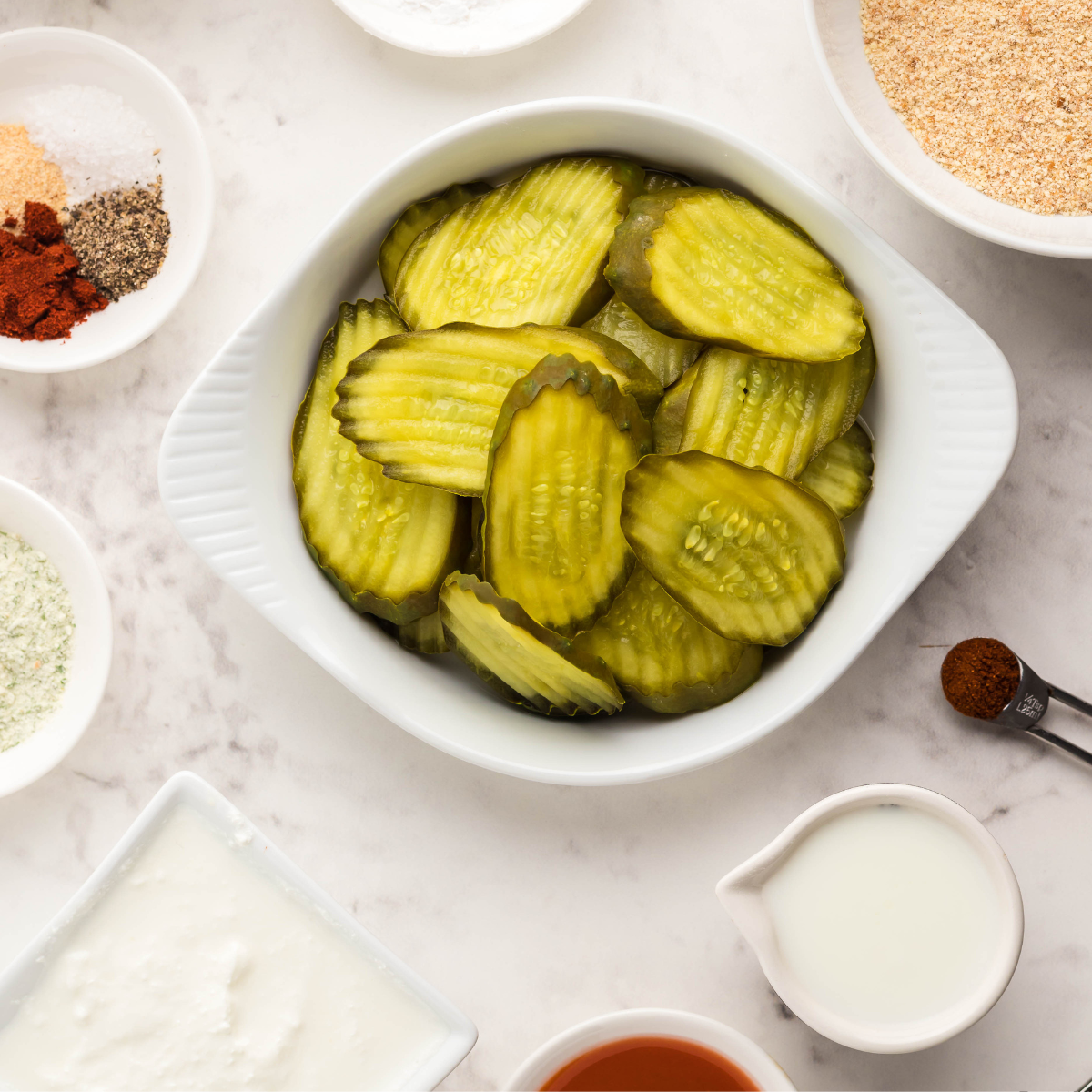 Ingredients for Air Fryer Doritos Pickle Chips laid out on a countertop.