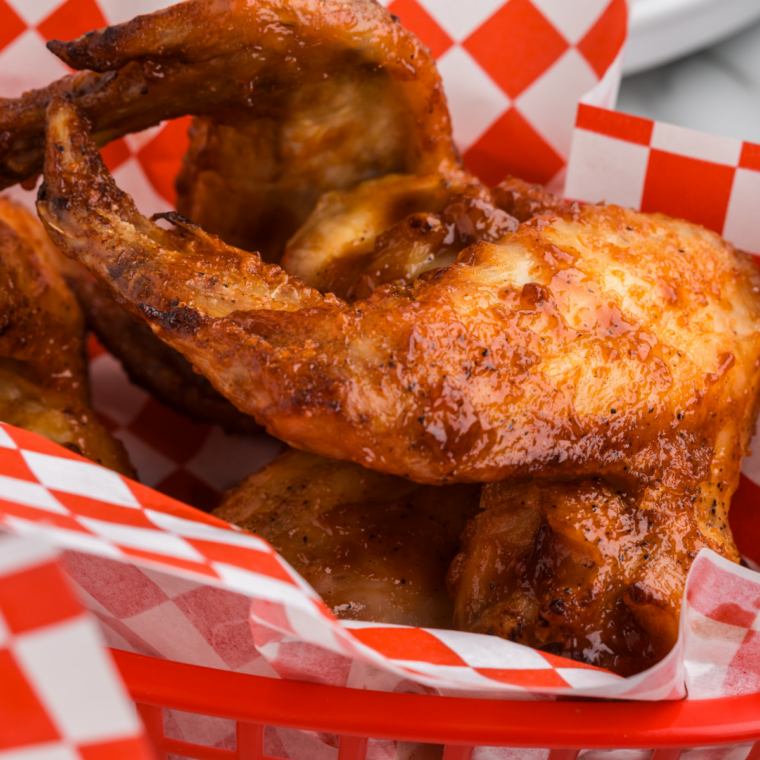 Golden crispy honey BBQ chicken wings fresh from the air fryer, coated in sticky glaze.