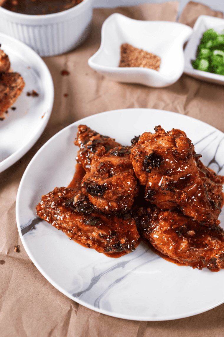 Pile of crispy Jack Daniel's wings drizzled with sweet smoky whiskey glaze