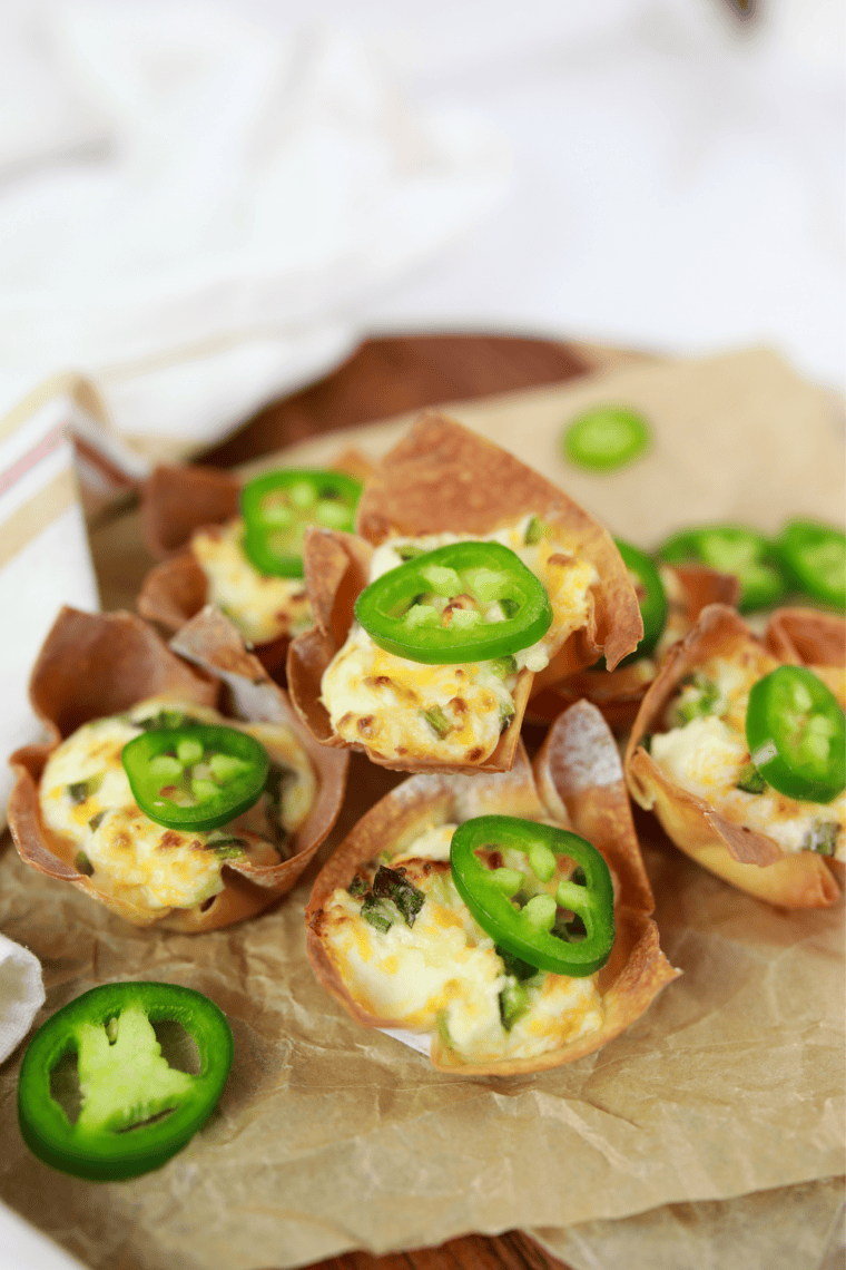 Air fryer jalapeno popper wonton cups piled on parchment paper