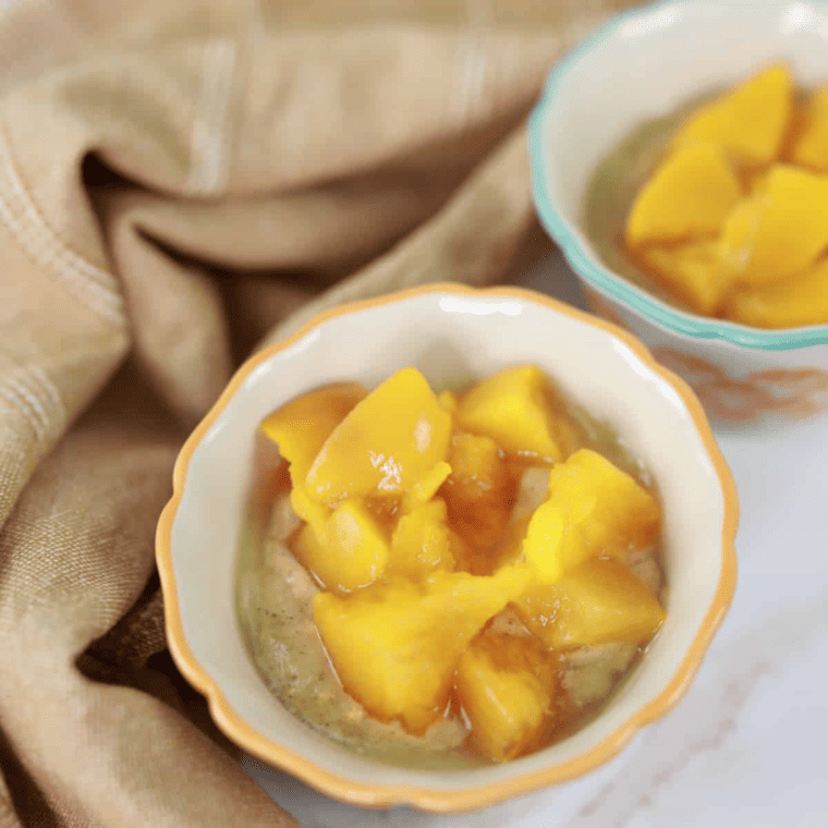 Ramekins filled with cake batter and diced peaches on top, ready to cook in the air fryer.