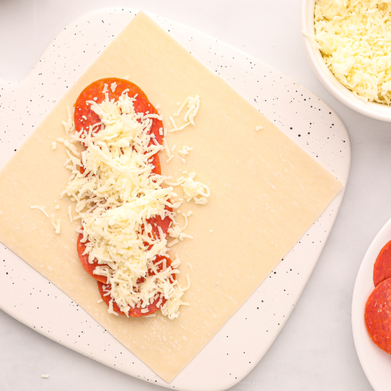 Mini pepperoni and shredded low-moisture mozzarella cheese for pizza egg roll filling