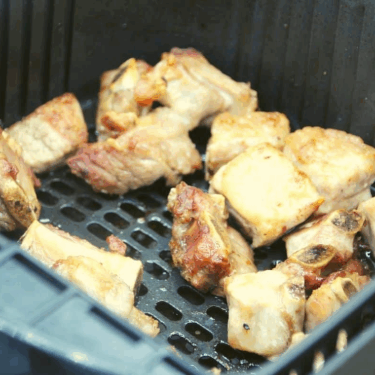 Cooked Pork Rib Tips in the air fryer basket.