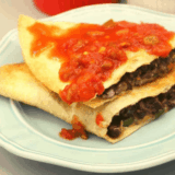 Crispy air fryer black bean quesadillas sliced and served on plate
