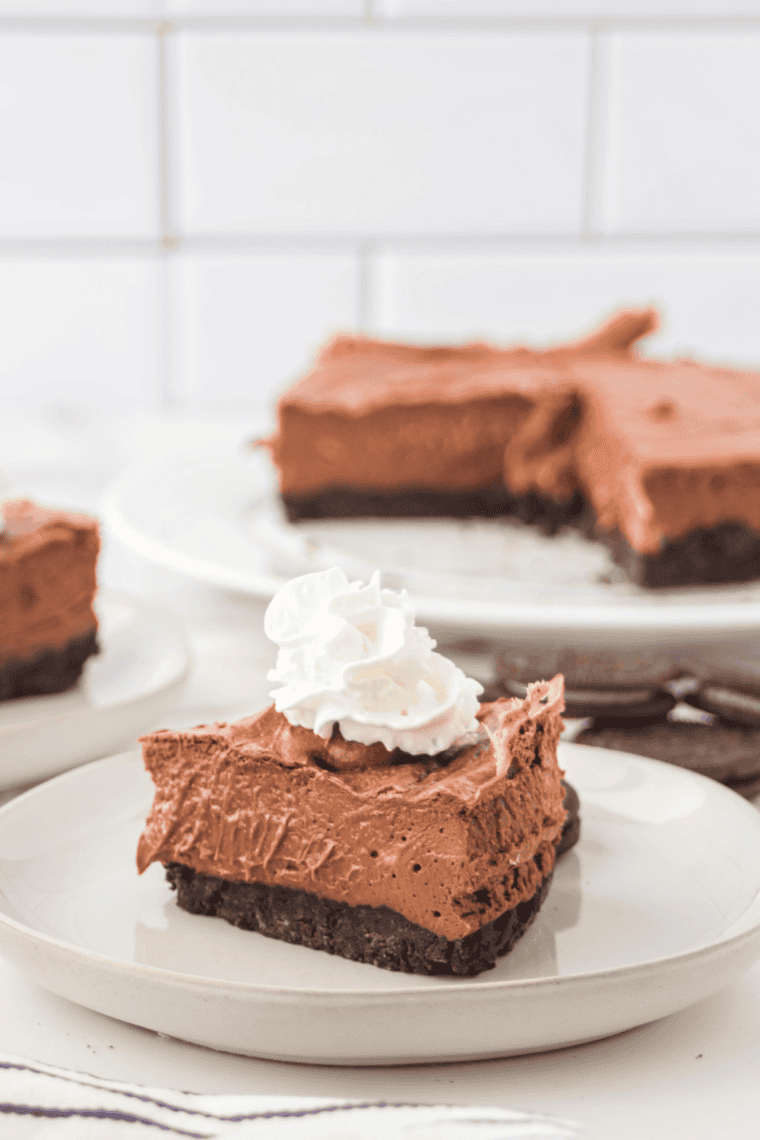 Slice of smooth, creamy chocolate cheesecake made in an air fryer, served on a plate.