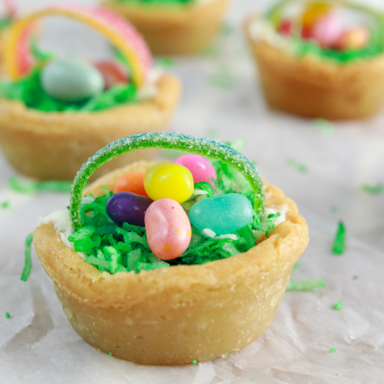 Adding frosting to attach Airhead handle, mixing green-dyed coconut, and filling Easter basket cookie cups.