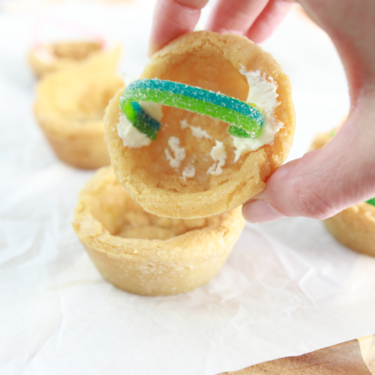 Cooling baked Easter basket cookie cups completely before decorating.