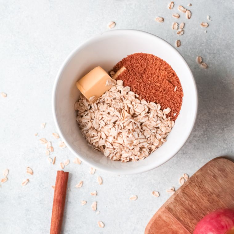 Oats, brown sugar, cinnamon, and butter being mixed in a bowl into a crumbly filling with optional nuts and dried fruit.