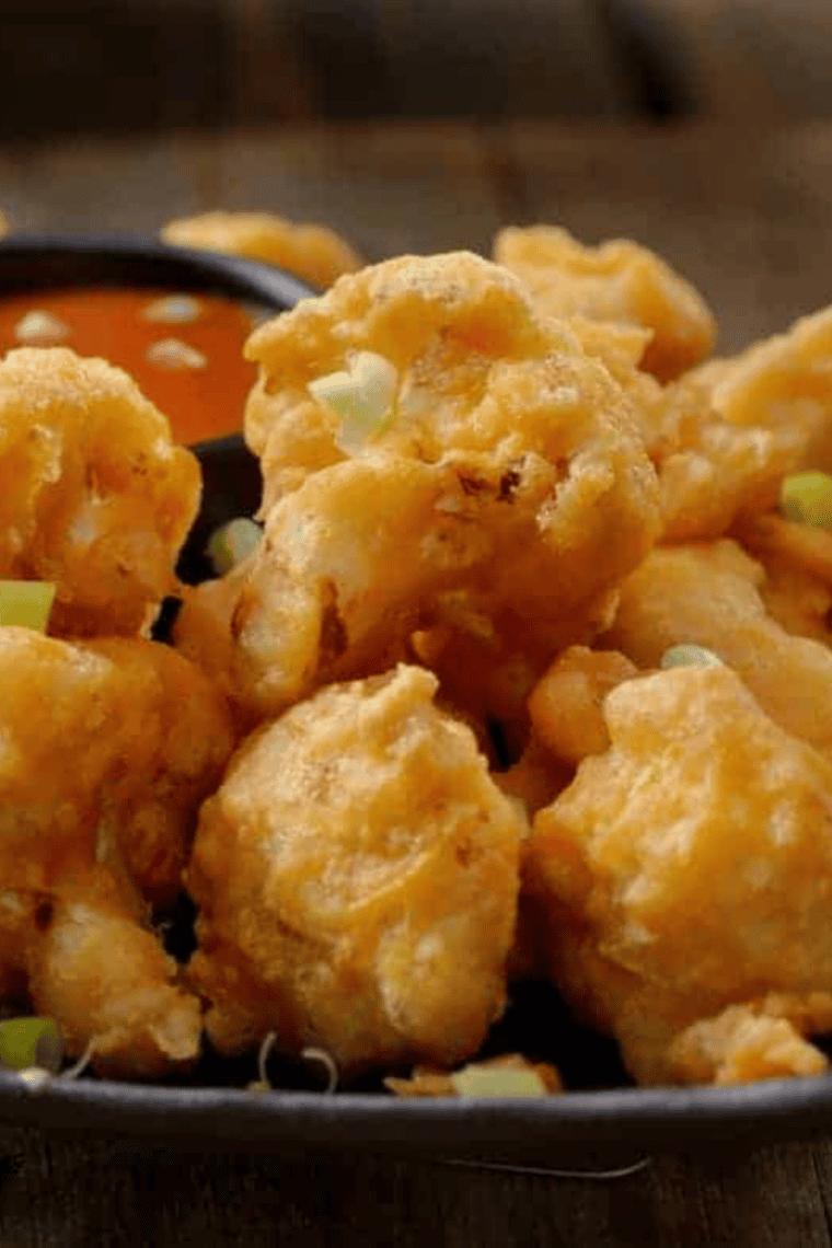 Golden, crispy air fryer frozen battered cauliflower served hot and ready to eat.