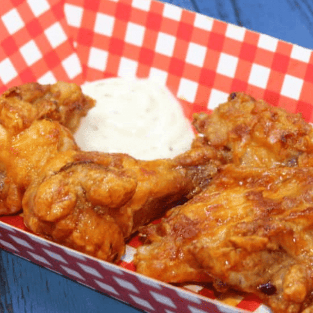 Air fryer buffalo chicken wings coated in Hooters-style sauce, served with celery and ranch dipping sauce.