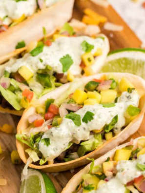 Air fryer mini taco boats filled with seasoned beef, cheese, lettuce, and pico de gallo