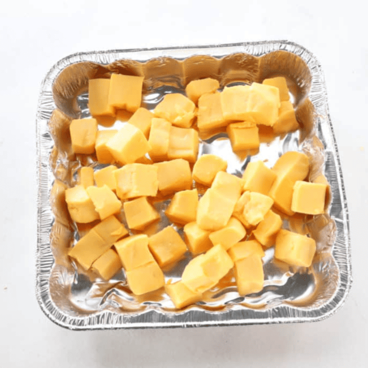 Ingredients laid out for making Air Fryer Queso, including cheese, salsa, and spices.