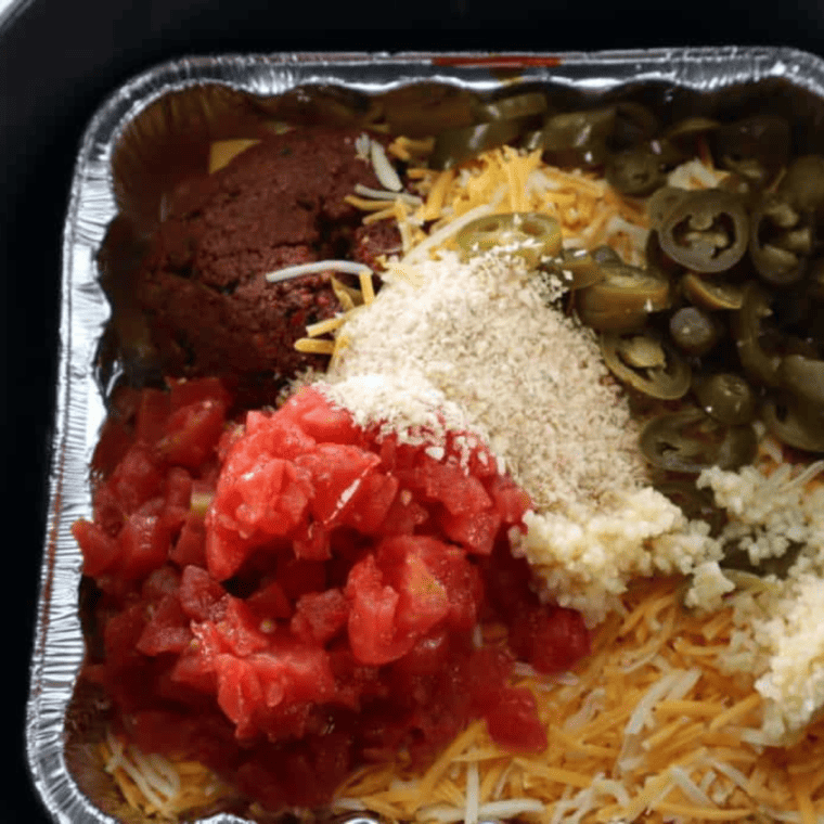 Mixing cheese and salsa in a bowl for Air Fryer Queso.
