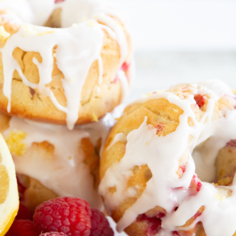 Plate of freshly made Air Fryer Raspberry Lemon Donuts with glaze