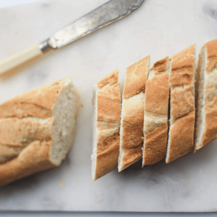 Baguette slices brushed with olive oil and arranged in a single layer in an air fryer basket